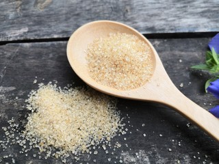 Brown sugar on a wooden spoon