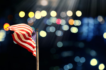 Conceptual image of waving American flag over abstract lights