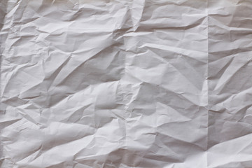 Old white crumpled paper background texture. Craft materials. Folds and bumps.