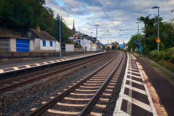 Small rural electric train station between hills of Hessen state in Germany