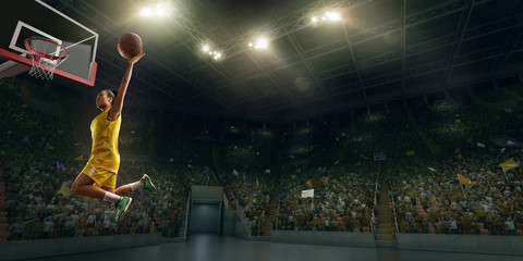 Female basketball player makes slam dunk. Basketball player on big professional arena during the game © Alex