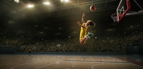 Female basketball player makes slam dunk. Basketball player on big professional arena during the game © Alex