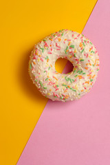 donut on pink and yellow background