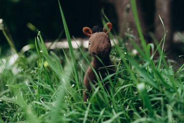 plush toy horse grazing in the grass
