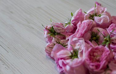 dry tea rose pink flowers on wooden