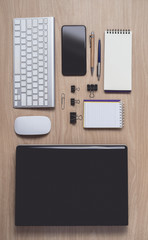 Workspace with diary or notebook and clipboard, laptop, mouse computer, keyboard, smart phone, pencil, pen on wooden background