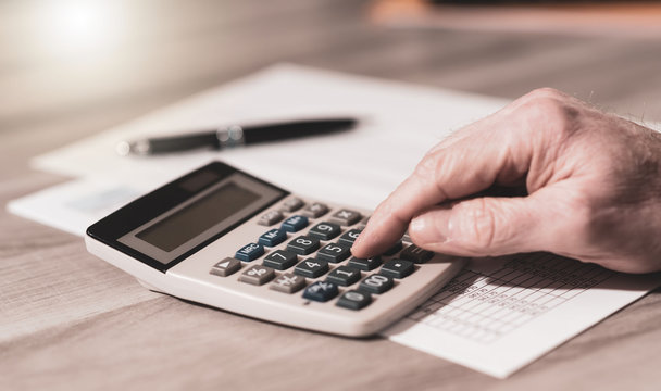 Hand using calculator, accounting concept