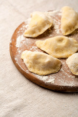 Raw dumpling on wooden board
