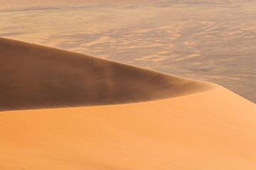 Fototapeta na wymiar wind on sand dune in Namib desert