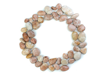 Round frame of small sea stones, isolated on white. Top view with copy space.