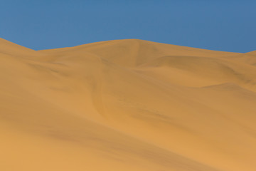 Fototapeta na wymiar many sand dunes in Namib desert, blue sky