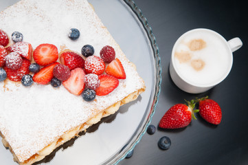 Round-shaped meringues on baking sheet. Close-up of baked crispy dessert. Recipe concept