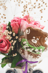 Bouquet of pink roses and gingerbread bear