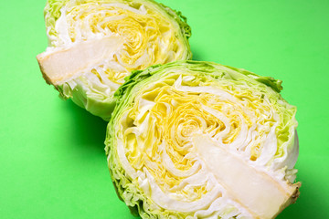Obraz premium Fresh cabbage head on green background