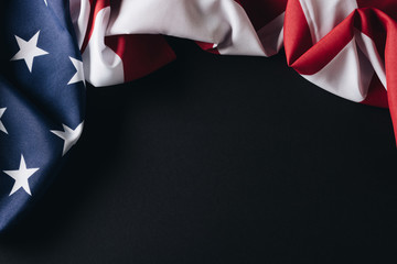 folded united states of america national flag isolated on black, memorial day concept