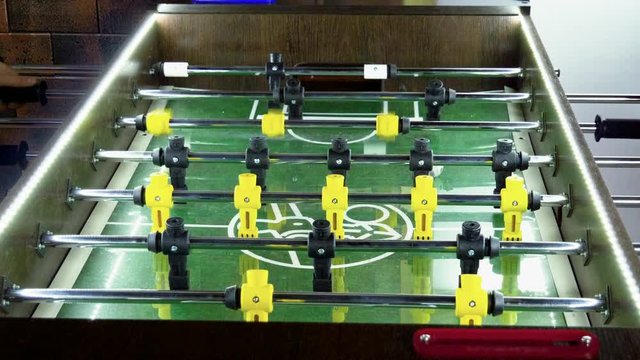 Sport, game concept. Foosball. Two men playing a table football or kicker with miniature players. 4K