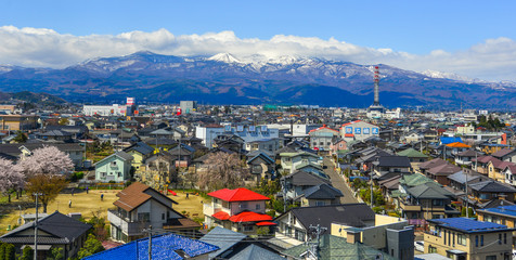 Cityscape with snow mountain in sunny day