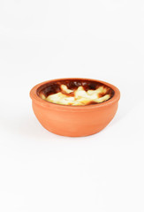 Turkish traditional sweet supangle dish in a clay plate on a white background 