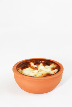 Turkish traditional sweet supangle dish in a clay plate on a white background 