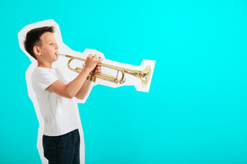 a child playing trumpet on turquoise background