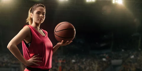 Poster Female basketball player with ball on big professional arena  © Alex
