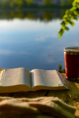 Devotional time outdoors: the Bible and a travel mug