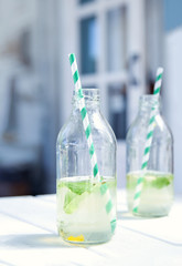 Two bottles with lemonade.