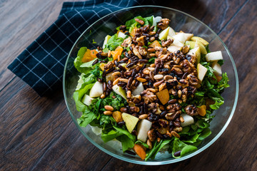 Pine Nut Salad with Walnut, Pear, Dried Apricot, Arugula or Rucola Leaves in Glass Bowl.