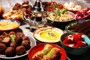 Middle eastern or arabic dishes and assorted meze, concrete rustic background. Falafel. Turkish...