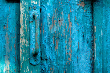 Vintage door pull handle on weathered scratched wooden surface. Concept of security and privacy protection. Textured grunge background