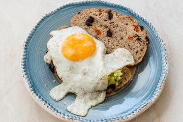 Fried Egg with Avocado on Toast Bread for Breakfast