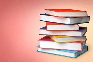 Colorful books collection on classroom background