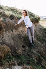 Naklejka premium Beautiful and happy woman girl have fun and relax in summer. Portrait of a beautiful girl on the Planer near the cliff. Freedom for a walk