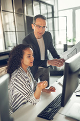 Curly African-American trainee asking her boss some questions