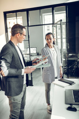 Obraz premium Secretary bringing samples of wooden desks for interior designer