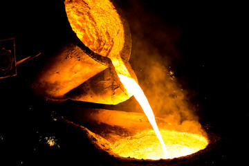 metal casting process with red high temperature fire in metal part factory