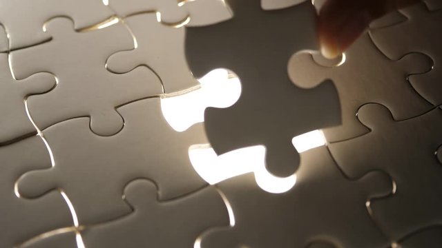 Piece of white jigsaw filling by hand, Success concept