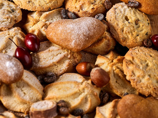 Oatmeal Cookies and sand chocolate cake with nut on wooden table in farm style close up. Perfect for breakfast.