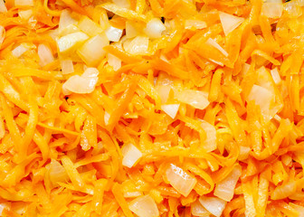 Fresh appetizing carrots finely RUB and fry with onions on a frying pan with oil. Preparation of carrots For garnish.