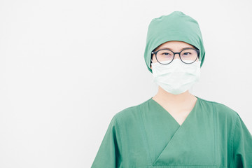 Portrait of young Asian nurse with surgeon uniform, wearing a surgical mask for protection from inhaling airborne bacteria or virus disease.