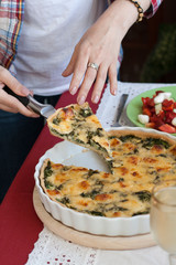 A gourmet lunch: spinach pie with cheese, a salad and wine.