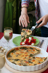 A gourmet lunch: spinach pie with cheese, a salad and wine.