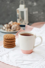 A tasty snack: a cup of tea and a stack of cookies.