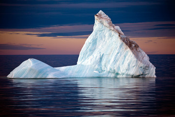 Isolated Iceberg  off the Coast of Greenland at Sunset with Resting Gulls. © Bruno