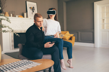 Young man and woman Using VR In The Living Room