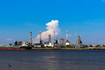 Oil refinery industry plant on blue sky  at beside Chao Phraya river, Thailand. 