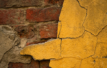 old red brickwork with broken yellow cement wall