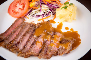 beef steak sliced  ready to eating on white plate