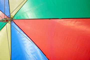 Colorful beach umbrella against sunny blue sky