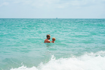 Father and son playing in the sea